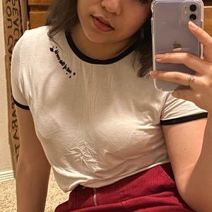 white tee with black “out of this world” embroidery